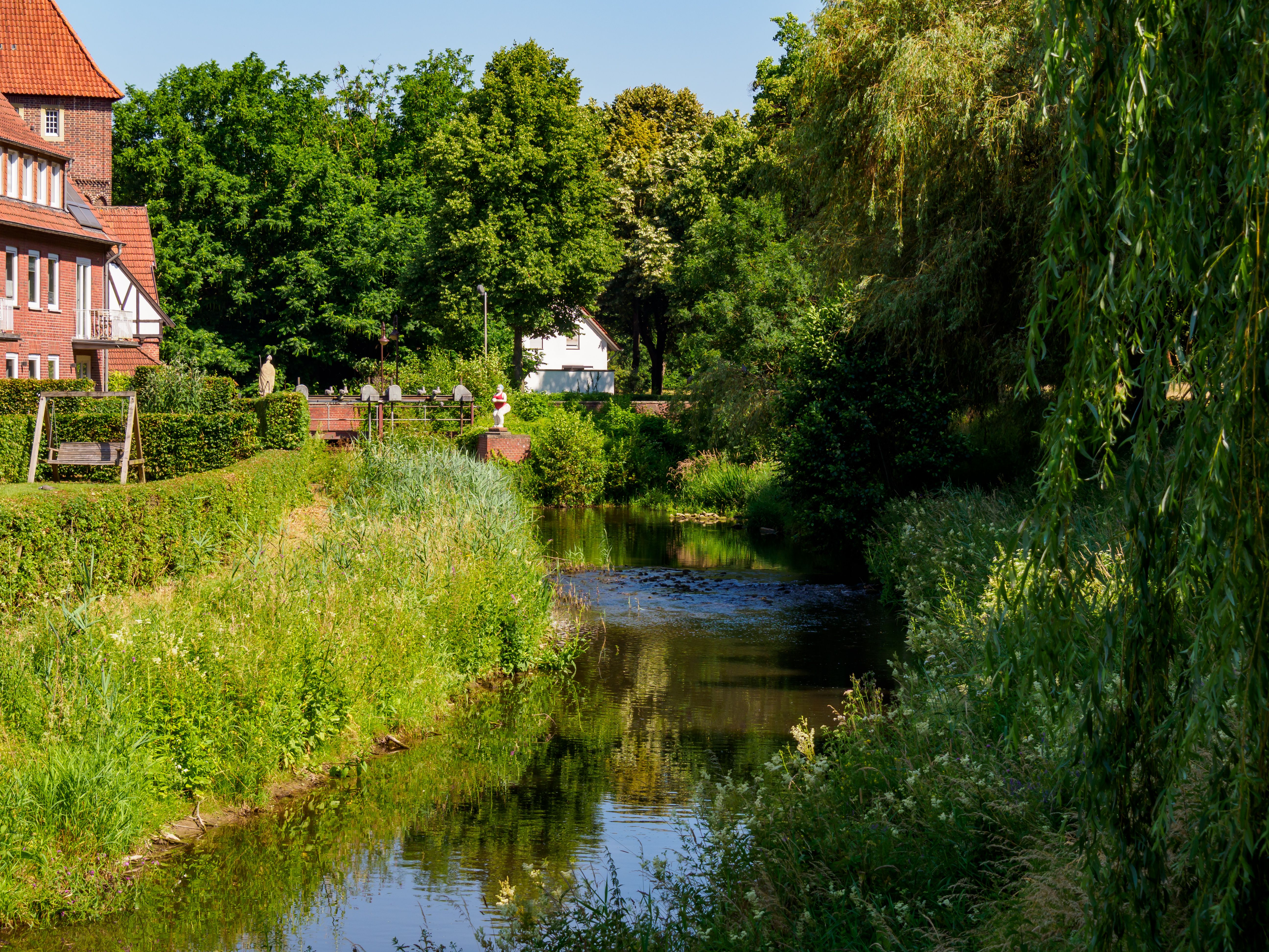 Idyllic summer scene of a canal and houses in Coesfeld, NRW, Germany. Perfect for travel and nature themes.
