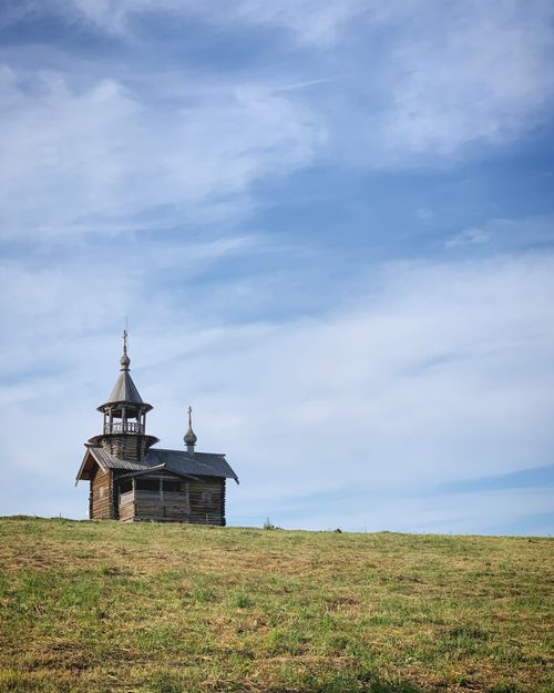Free A serene view of a wooden chapel on Kizhi Island, Russia, under a blue sky. Stock Photo