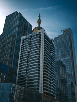 Tall modern skyscrapers standing against a clear blue sky, showcasing urban architecture.
