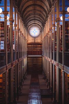 Explore the grandeur of a historic library's architecture, featuring a stunning stained glass window.