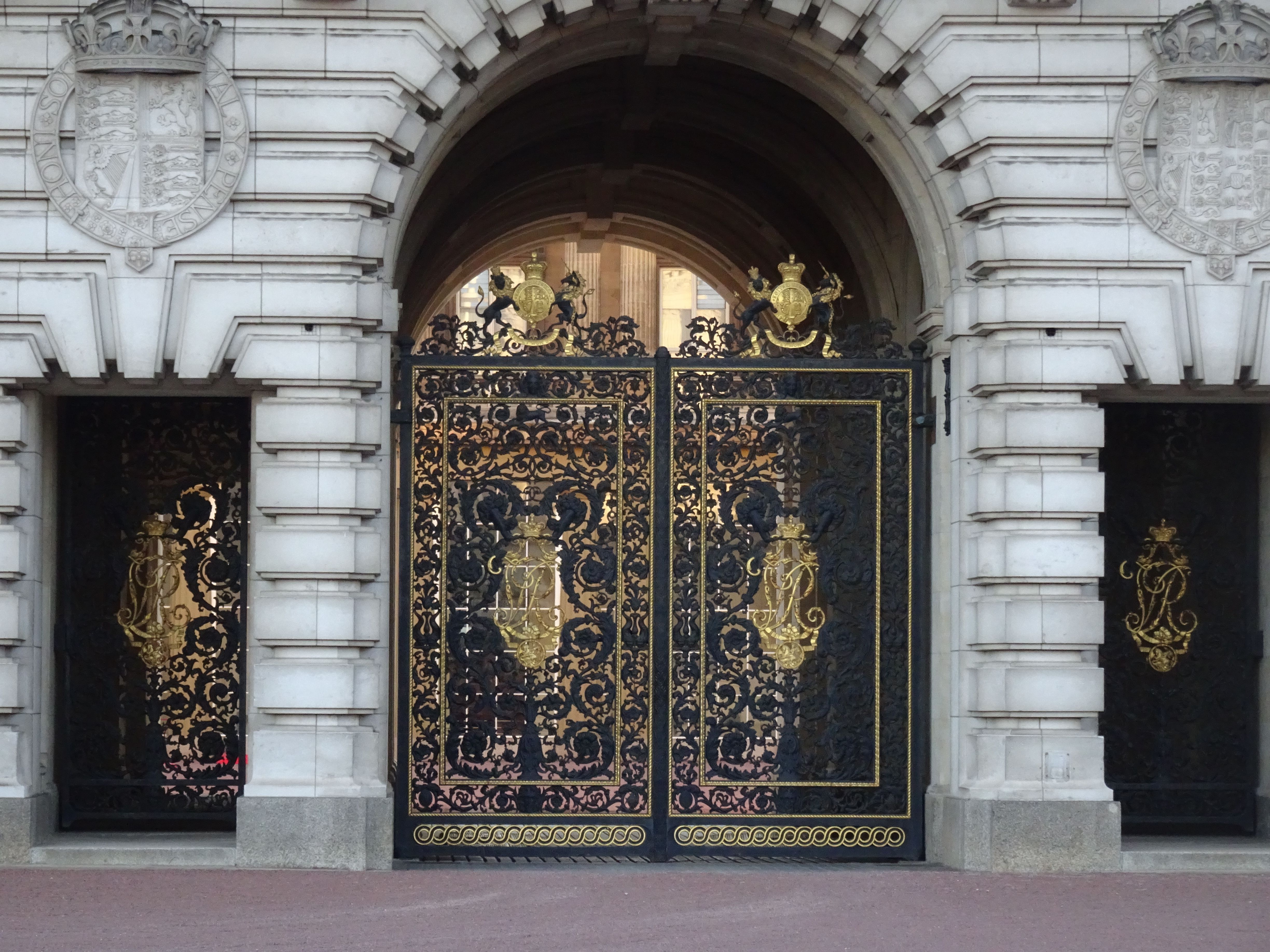 Close-up view of the ornate iron gates at Buckingham Palace, London.
