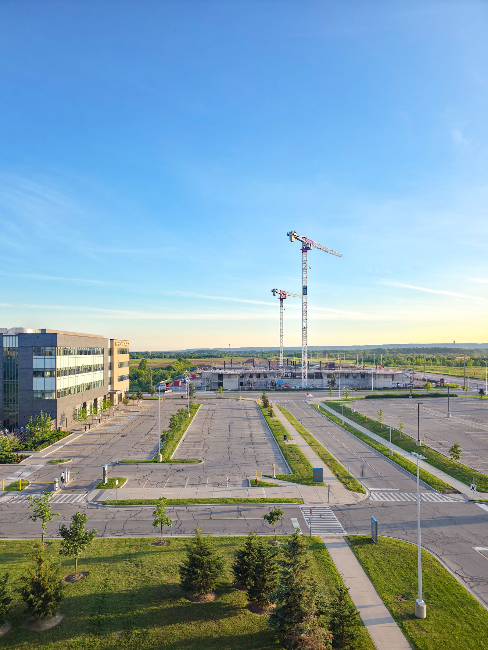 Aerial view of a construction site with tower cranes in Oakville, Ontario