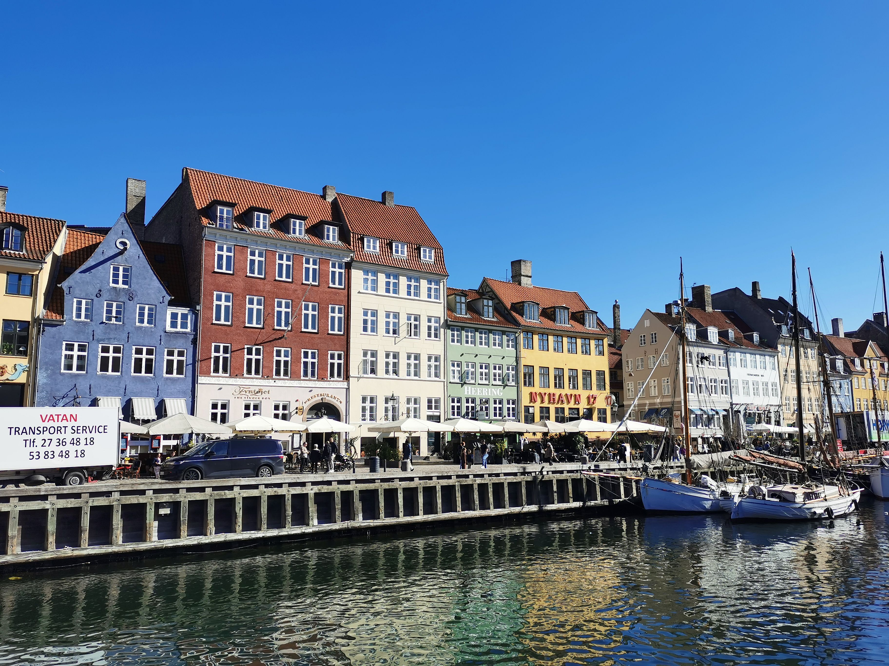 Vibrant Nyhavn canal with colorful buildings and boats in Copenhagen.