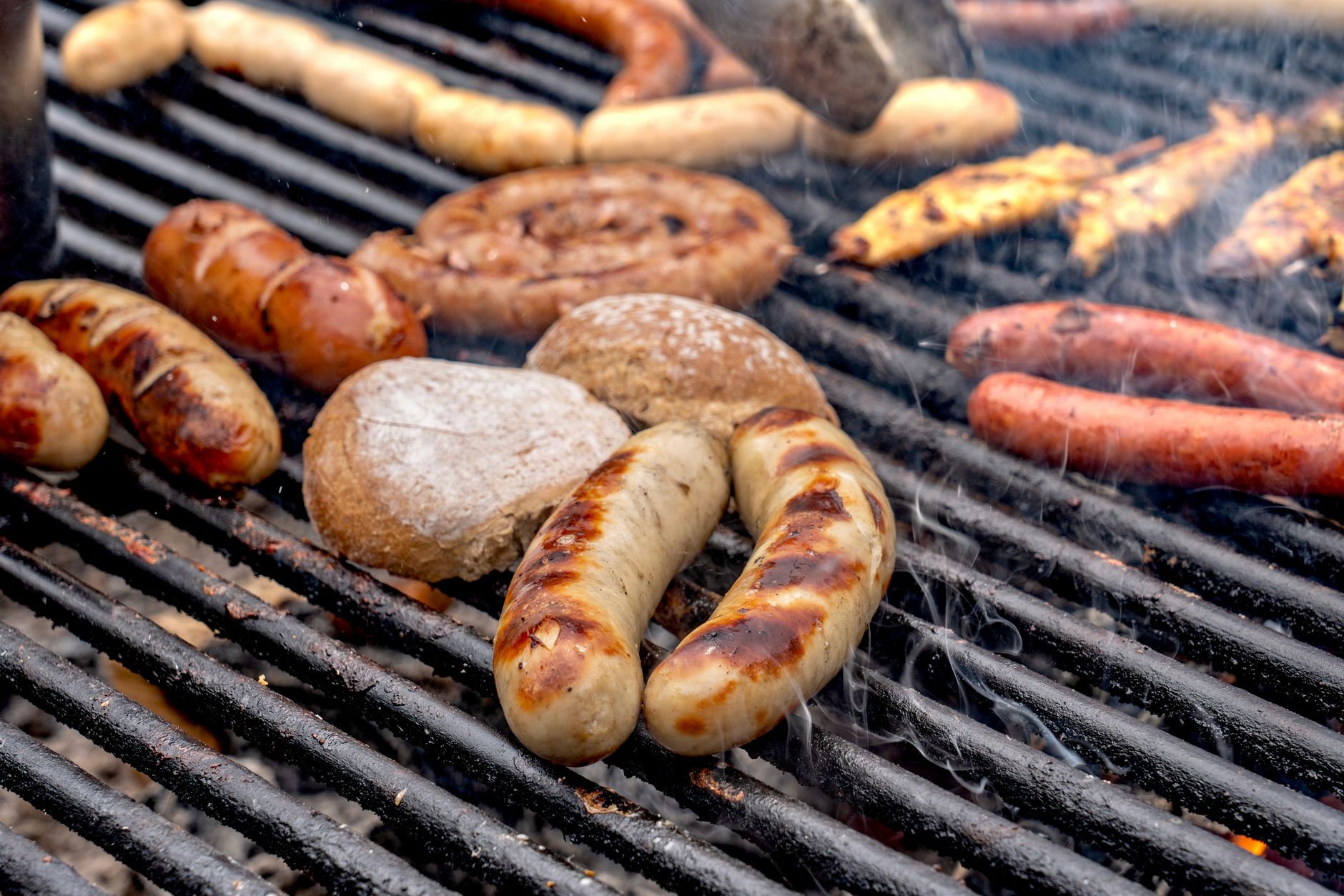 Bratwurst with mustard and sauerkraut in a bun ready to eat