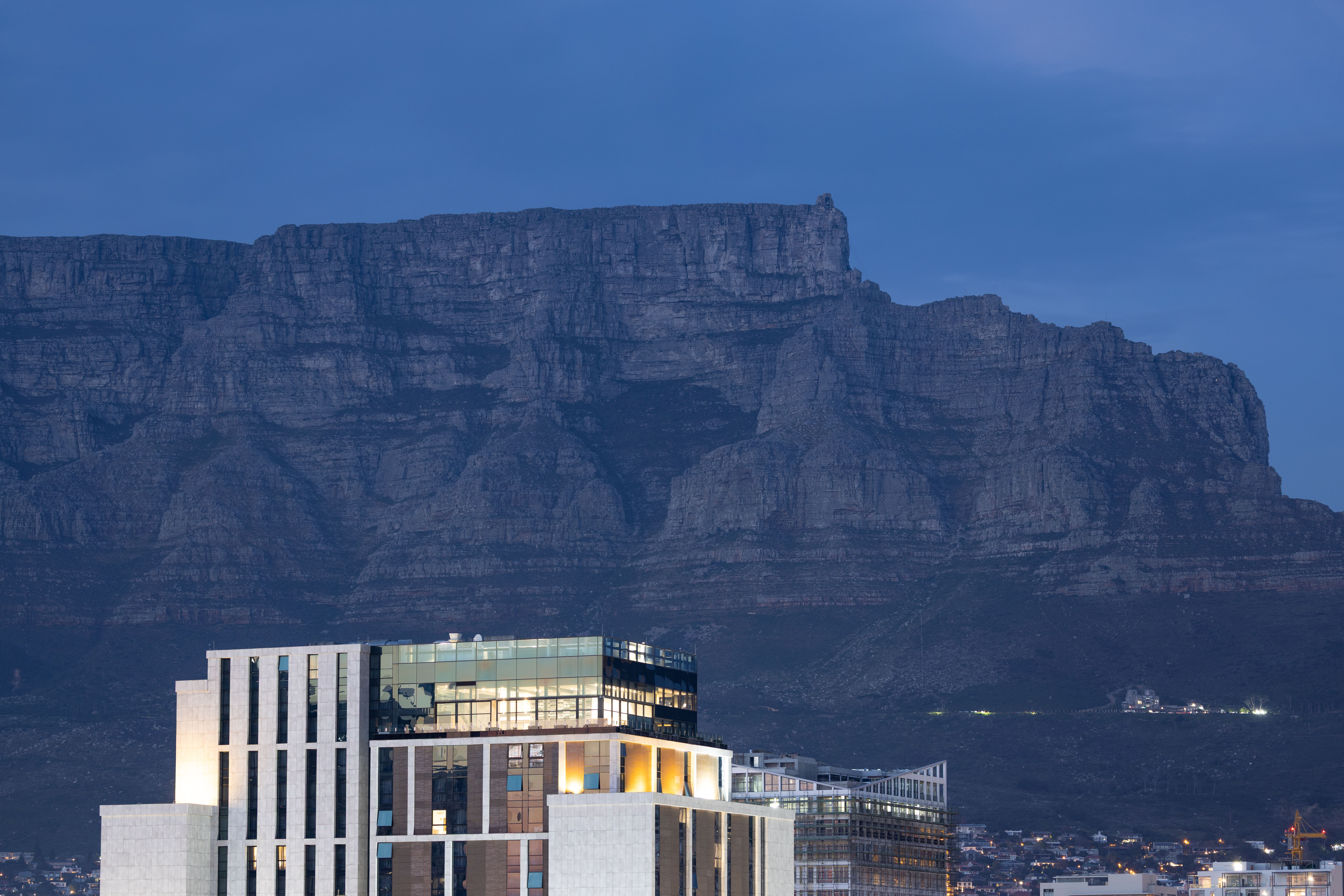 Hotel room window framing the flat summit of Table Mountain