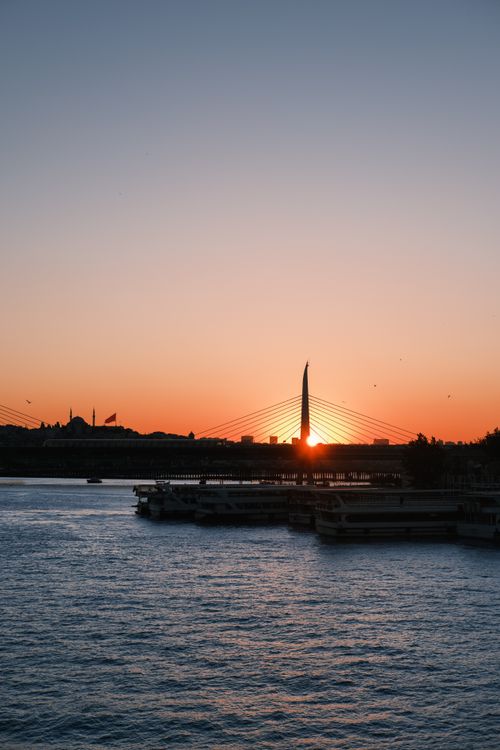 Free Beautiful sunset view over the Istanbul bridge with silhouettes and calm waters. Stock Photo