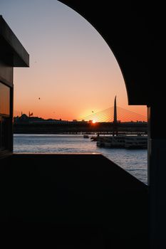 Captivating sunset over Istanbul bridge with silhouette of cityscape and waterfront view.
