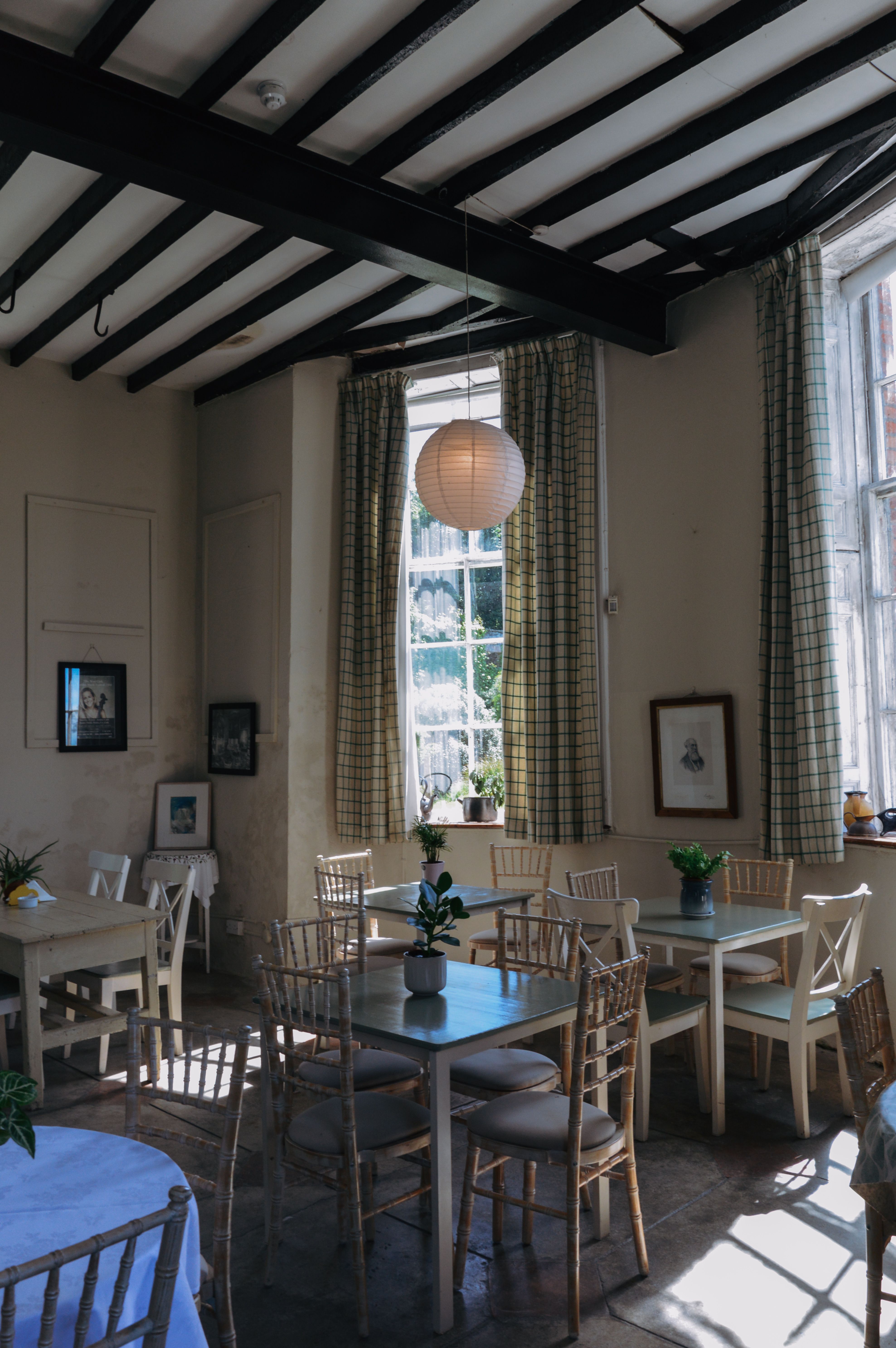 A charming, sunlit café in Bantry, Ireland, featuring rustic decor and natural lighting.
