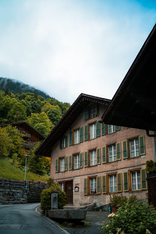 Free Explore the picturesque architecture of a traditional Swiss house nestled in the scenic village of Lauterbrunnen. Stock Photo
