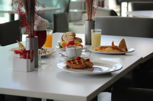 Free A beautifully arranged breakfast table with waffles, fruits, and drinks in a Zacatecas restaurant. Stock Photo