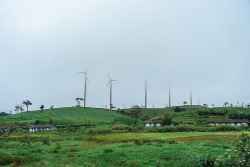 Free Serene landscape of wind turbines on lush green hills in Ambewela, enhancing renewable energy in Sri Lanka. Stock Photo