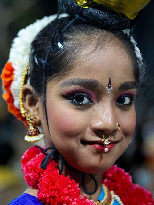 Free Portrait of a young girl adorned in vibrant traditional Indian dance attire with intricate makeup and accessories. Stock Photo