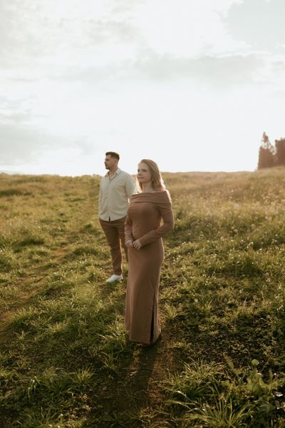 Two people in a grassy field at golden hour — photo by Alexander Mass on Pexels