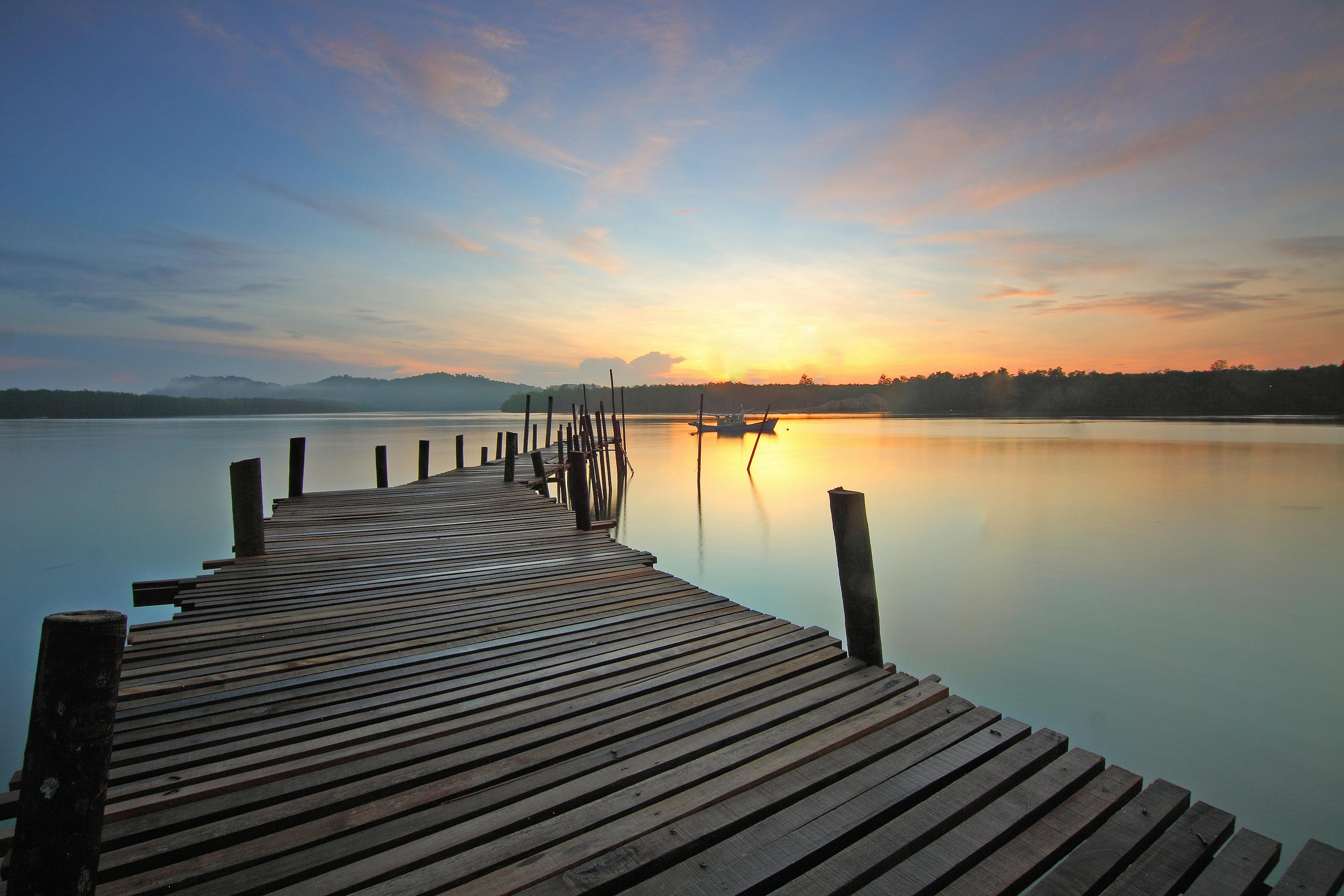 Brown Wooden Dock on Calm Body of Water Surrounded by 