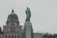 View of Saint Joseph's Oratory and statue in Montreal, Canada, on a cloudy day.