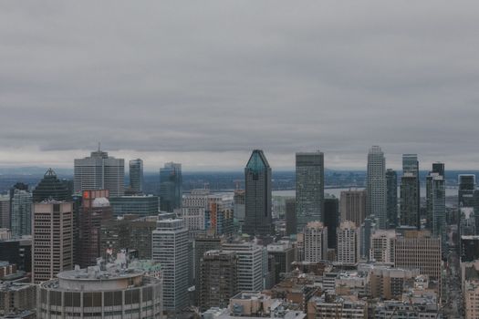 Aerial view of Montreal's skyline showcasing the city's modern skyscrapers under a cloudy sky.