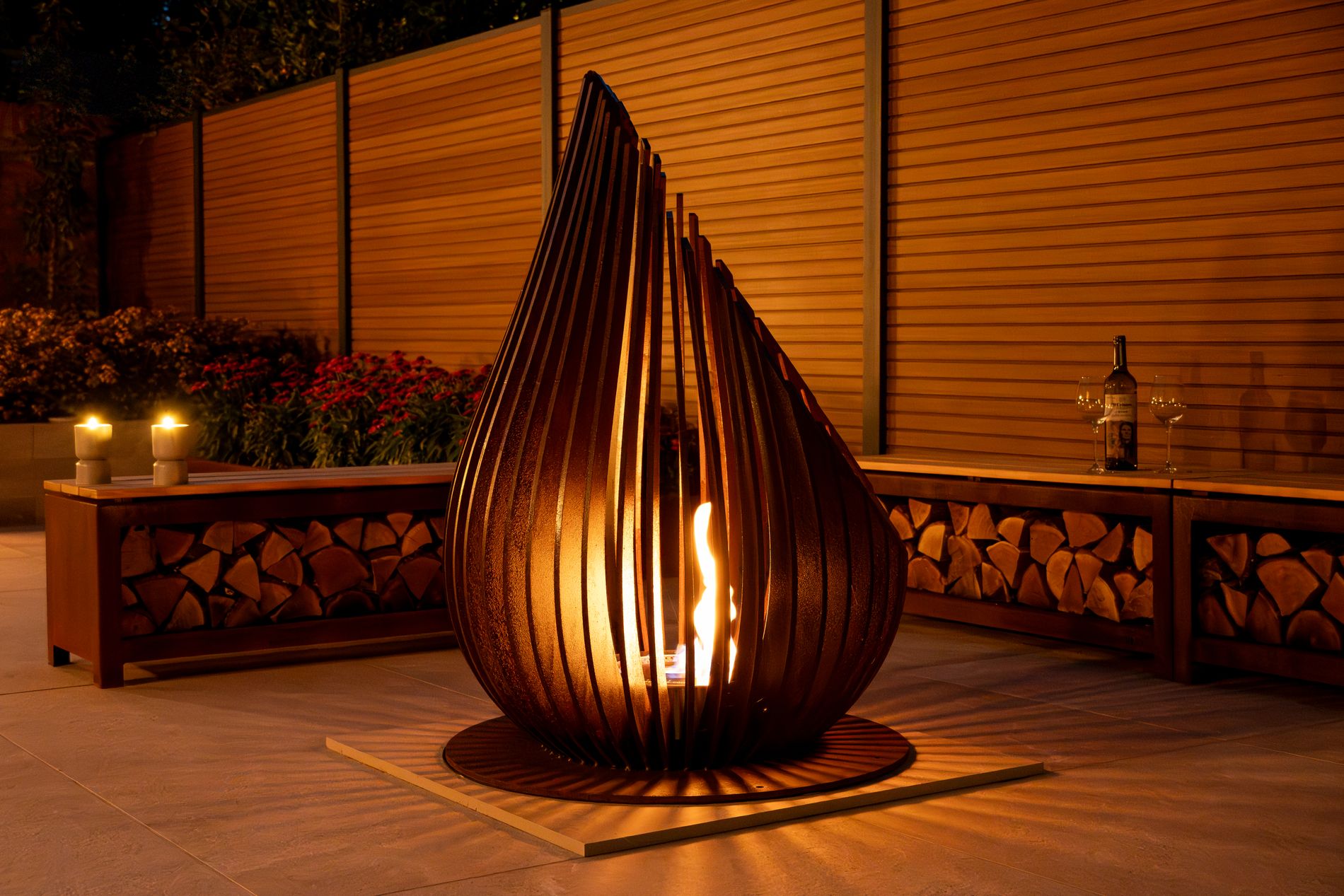 Modern outdoor fire feature glowing at night