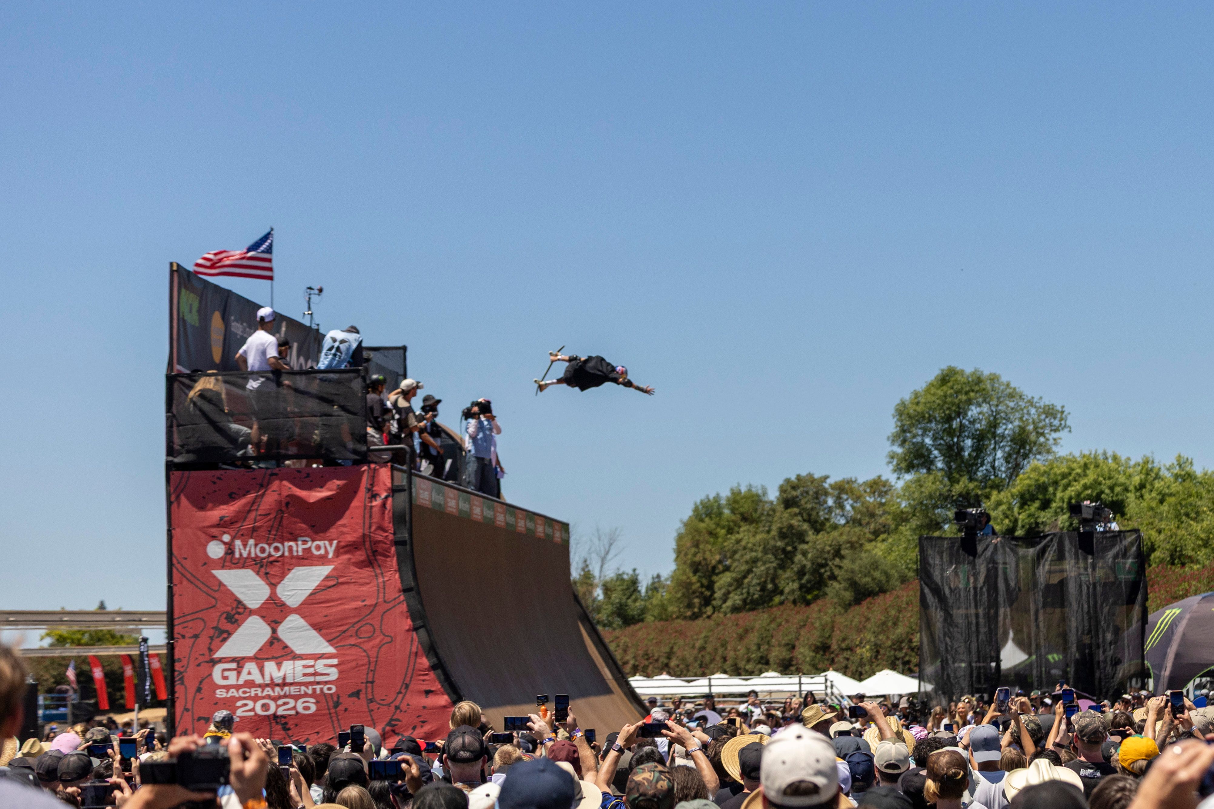 Exciting skateboard stunt at X Games 2026 in Sacramento, captured mid-air with crowd spectators.