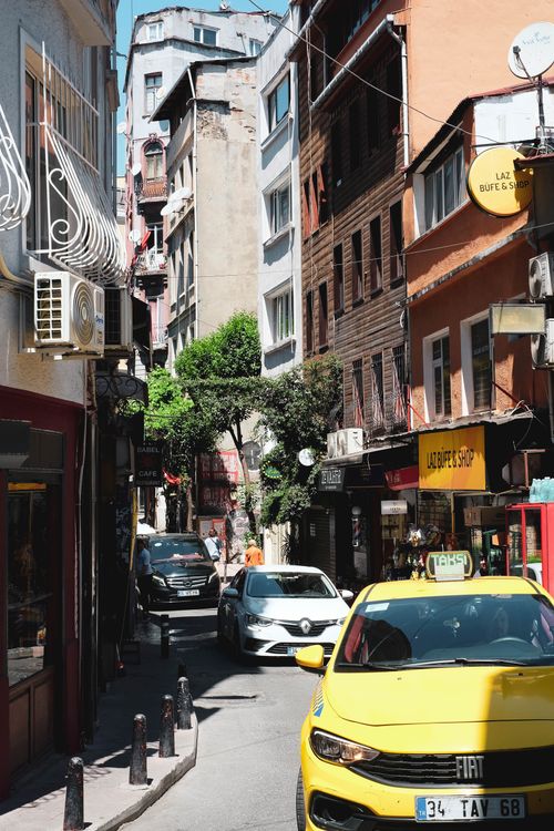 Free Colorful street scene in Istanbul with shops, cars, and vibrant architecture. Stock Photo