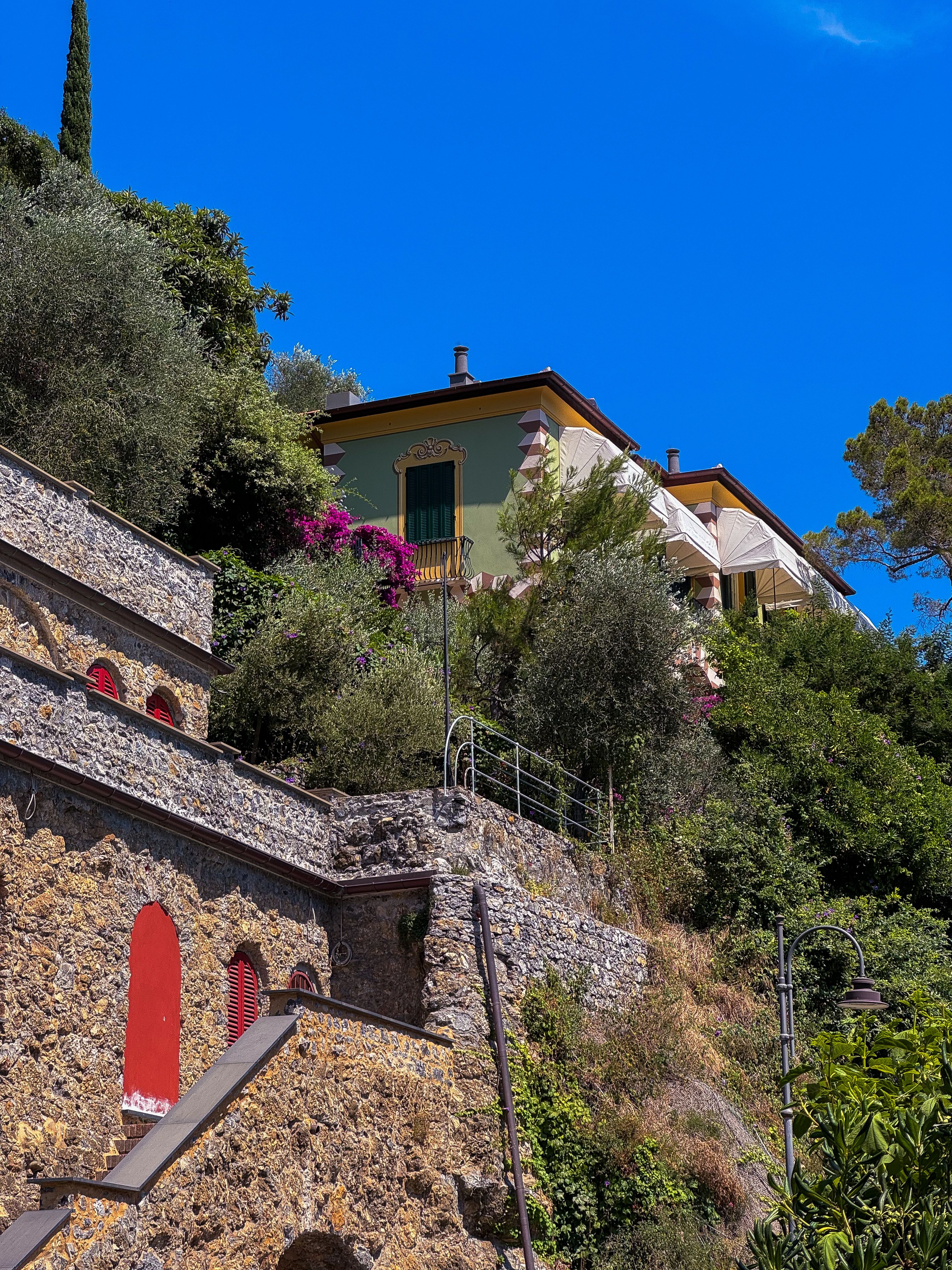 Charming villas amidst lush greenery in Portofino, Liguria, Italy.