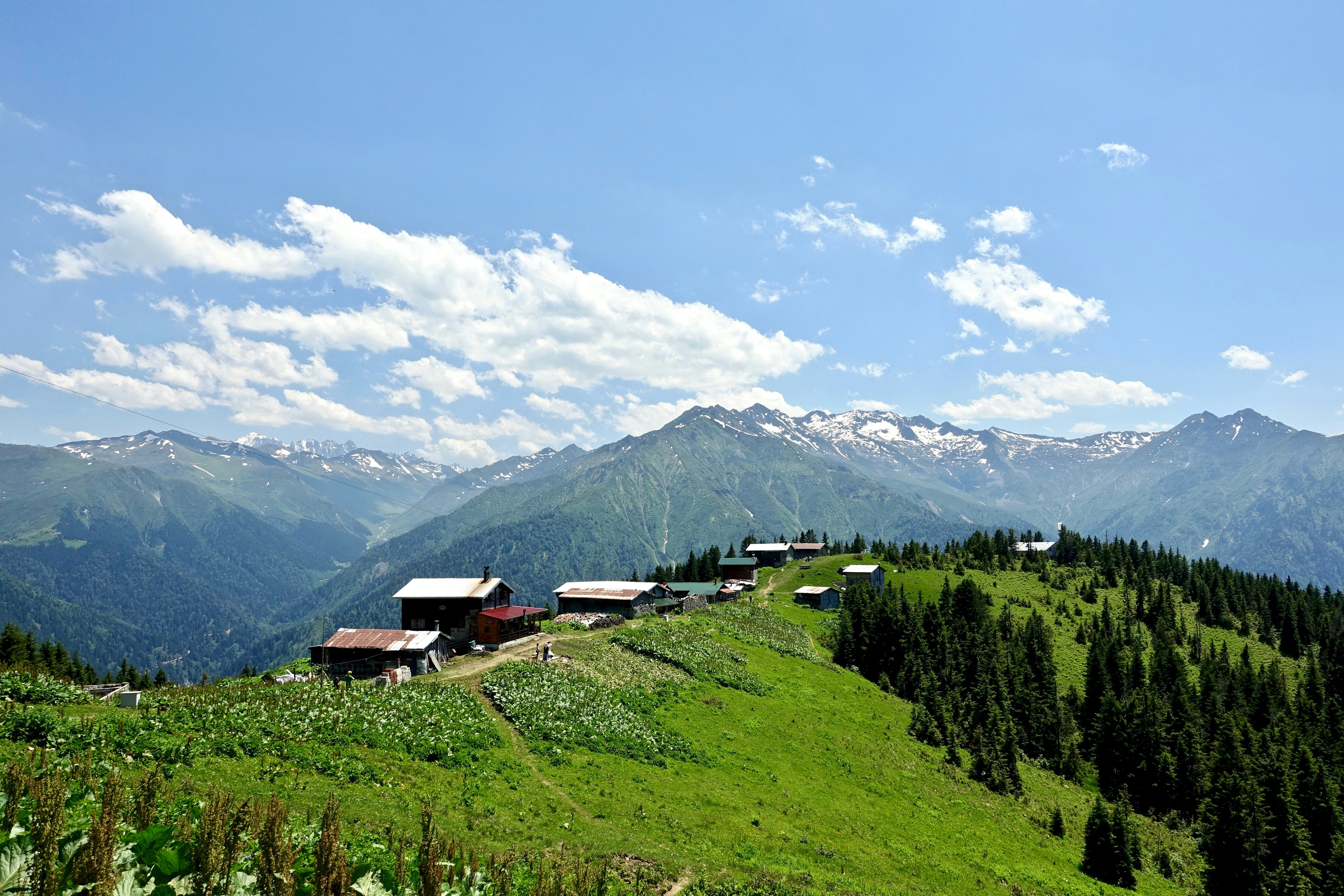 Mount Adaklu peak with green hills and distant villages under blue sky