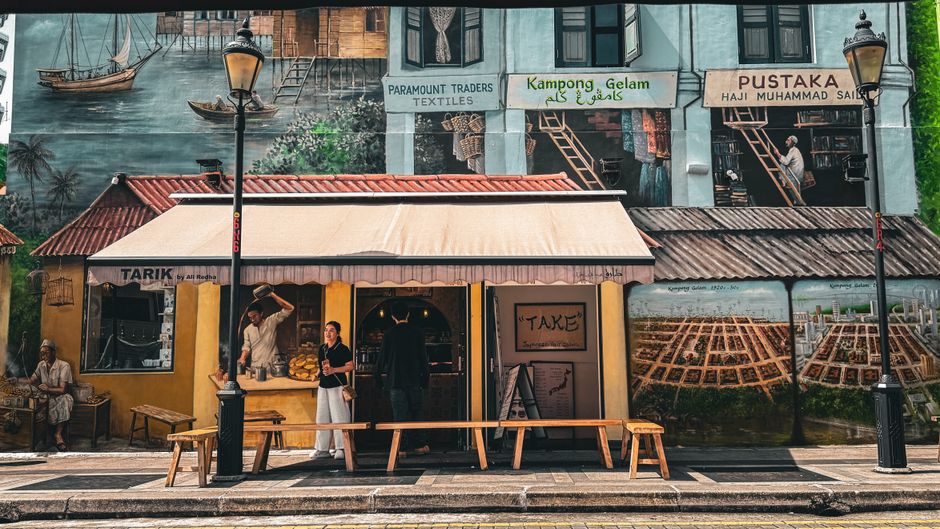Traveler with luggage exploring a vibrant Singapore street market, illustrating baggage protection.