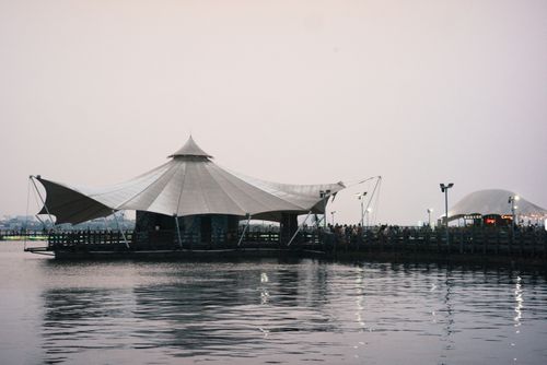 Free Peaceful scene of a unique tent-like structure at Jakarta's waterfront during dusk. Stock Photo