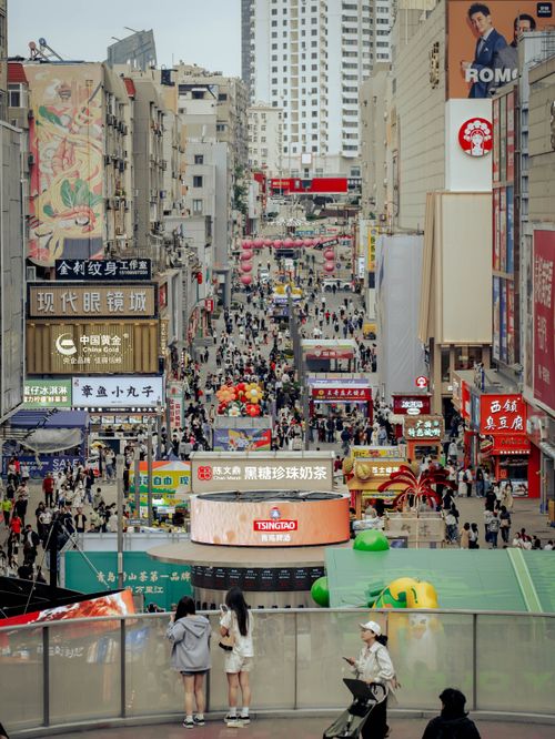 Free Bustling street scene filled with people and colorful signs in an urban Asian shopping district. Stock Photo