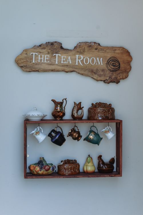 Free Wooden wall display of vintage tea sets and fruit decor in Bantry tea room. Stock Photo