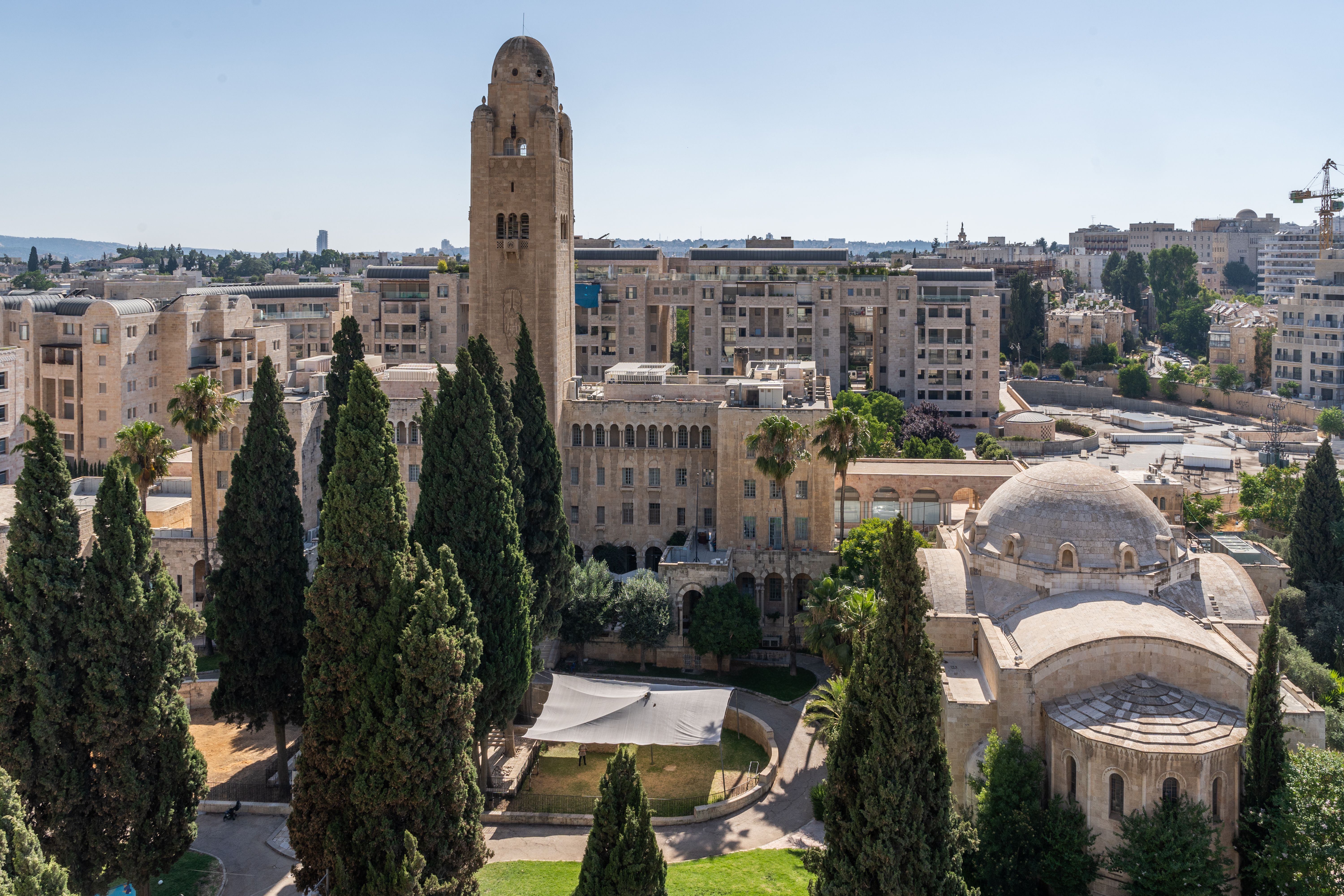 Aerial view of Jerusalem showcasing historic architecture and skyline on a clear day.