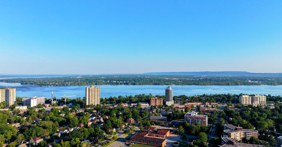 Aerial view of Hamilton, Ontario skyline and Lake Ontario on a clear sunny day.