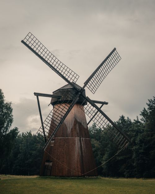 Free Historic wooden windmill in scenic Tallinn, Estonia, surrounded by lush greenery. Stock Photo