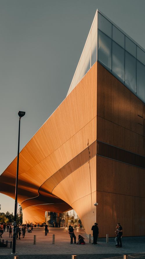 Free Modern design of Helsinki's Oodi Library captured at sunset highlighting its striking architecture. Stock Photo