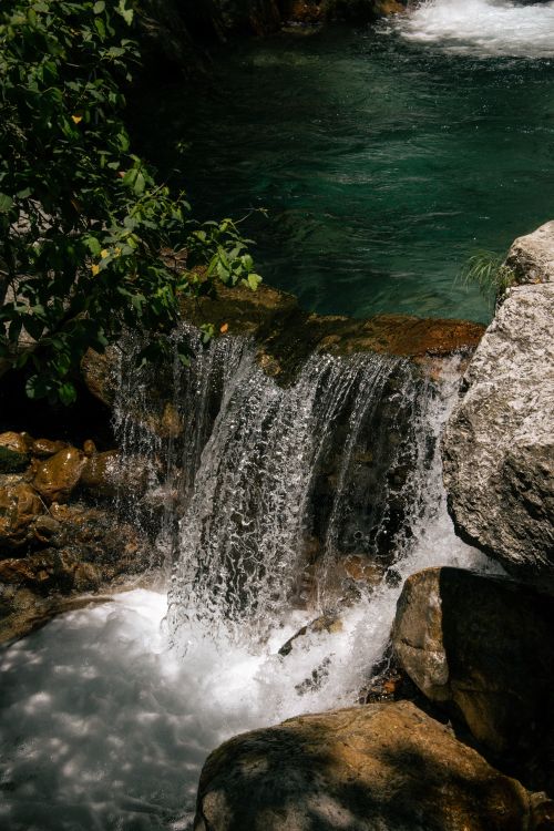 Free A tranquil waterfall cascading over rocks in Sapadere, Antalya, Türkiye. Stock Photo