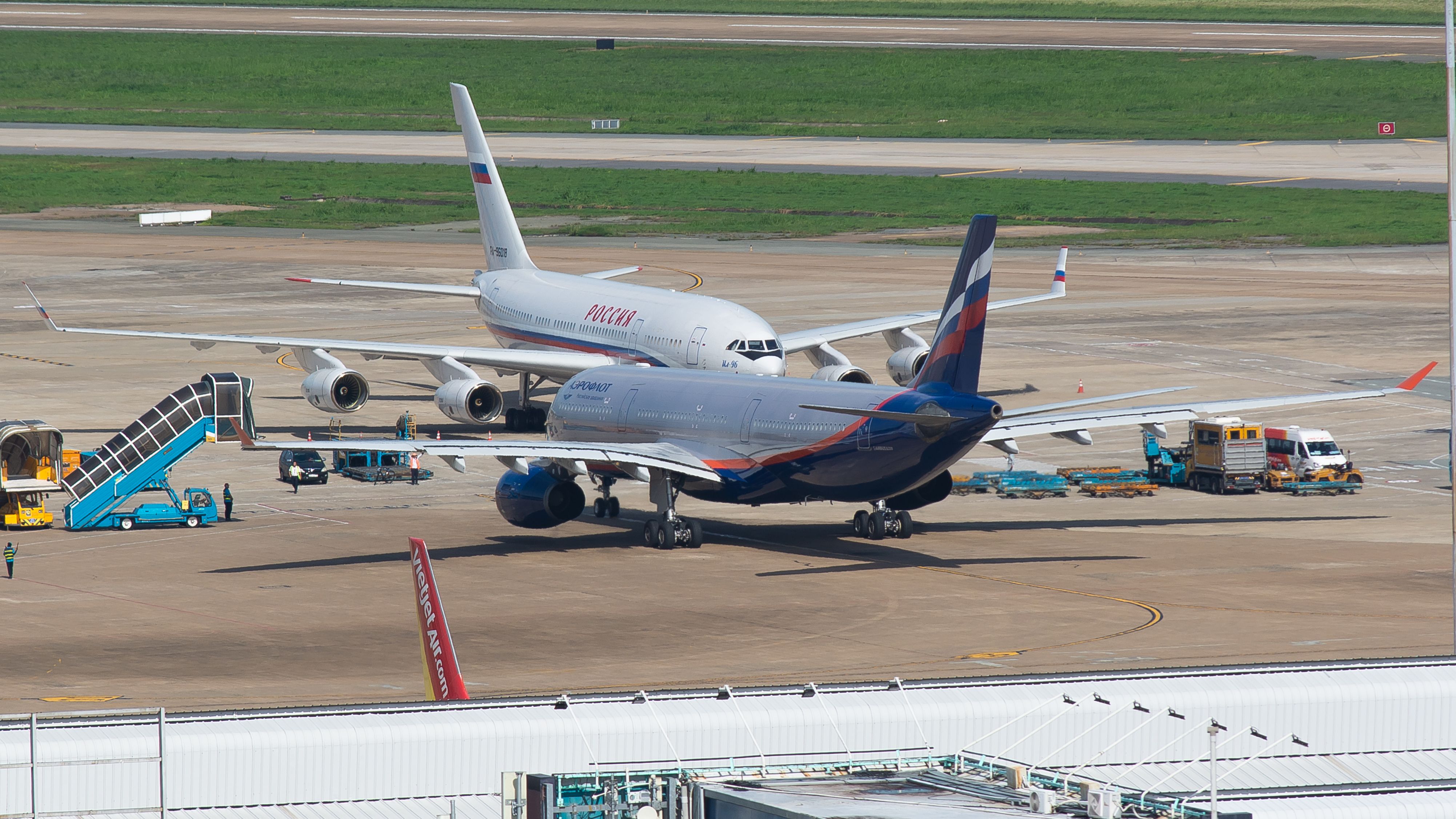 Passenger airplanes on the tarmac at an airport, ready for boarding and departure.