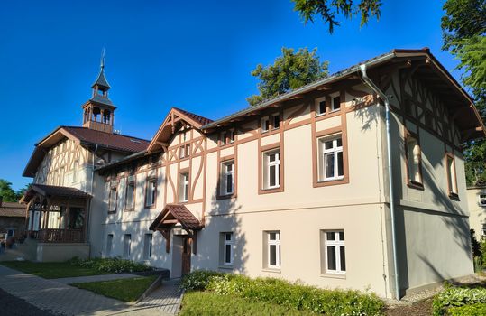 A beautiful example of historic timber-framed architecture under a clear blue sky.