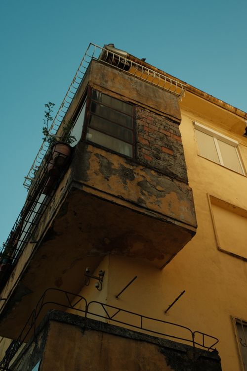 Free Close-up of aging balconies on an old building in Shkodra, Albania, showcasing rustic textures. Stock Photo
