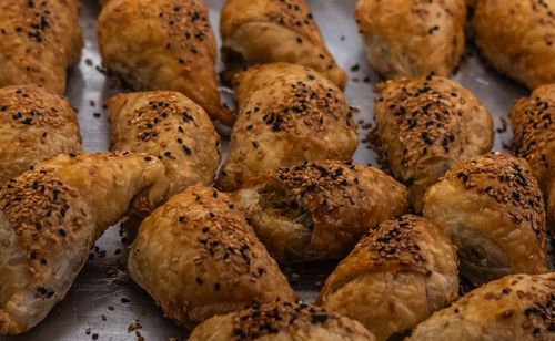 Free Freshly baked Turkish pastries sprinkled with sesame seeds, captured in İzmir. Stock Photo