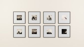 Printed photographs pinned on a pale wall — photo by Medhat Ayad on Pexels