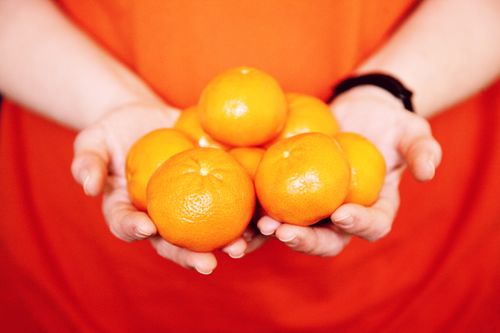 Free Hands holding fresh, juicy oranges, symbolizing health and freshness. Stock Photo