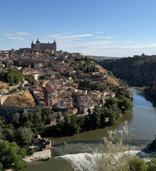 Explore the stunning historic architecture of Toledo, Spain, with its iconic Alcázar overlooking the city and river.