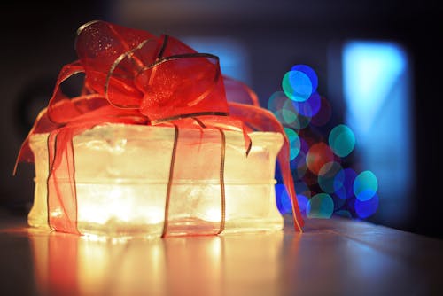 Free Lighted Gift Box with Red Bow Ribbon  Stock Photo