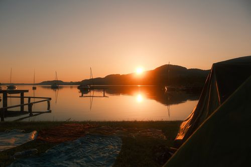 Free A serene sunset view over a lake in Salzburg, Austria, perfect for camping enthusiasts. Stock Photo