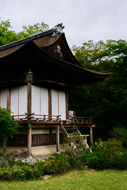 Free Serene view of a traditional Japanese temple surrounded by lush greenery in Kyoto, Japan. Stock Photo