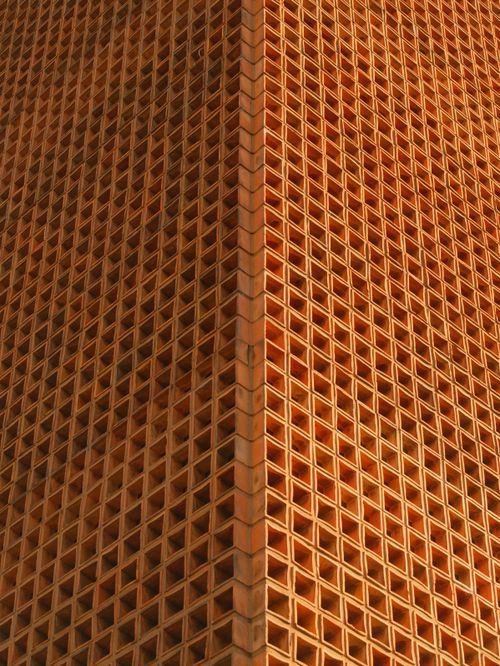 Free Close-up view of a geometric brick facade showcasing intricate architectural design in Brazil. Stock Photo
