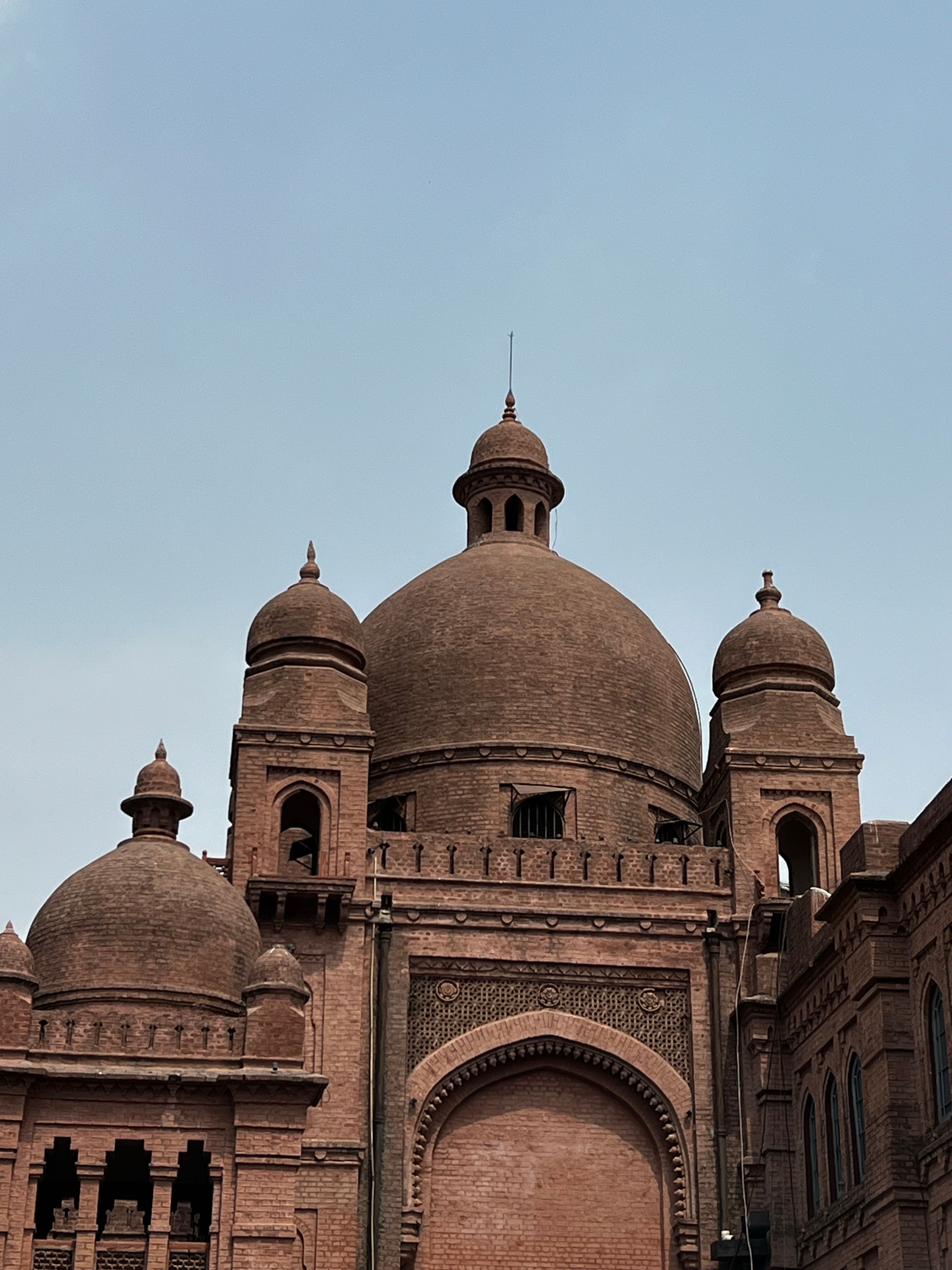 A historic domed landmark in Lahore under a clear sky