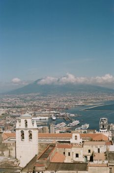Aerial view of Naples, Italy, featuring Mount Vesuvius and the coast.