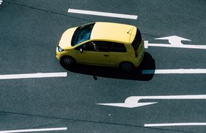 Aerial view of a compact hatchback on a marked road — photo by wal_ 172619 on Pexels