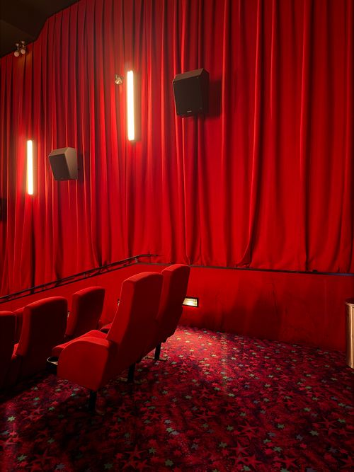 Free Cozy and luxurious red theater seating and curtains, ready for a cinematic experience. Stock Photo