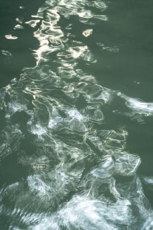 Free Mesmerizing abstract patterns of light reflecting on a water surface in Dehradun, India. Stock Photo